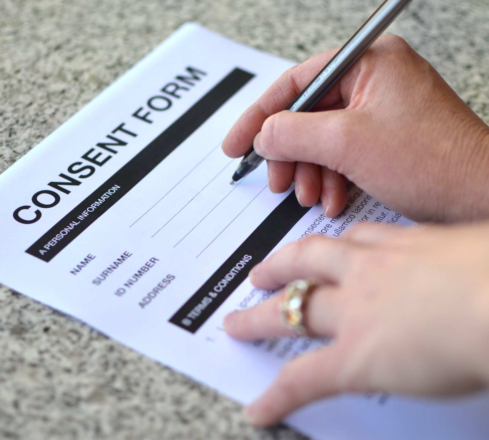 A woman signing a consent form.