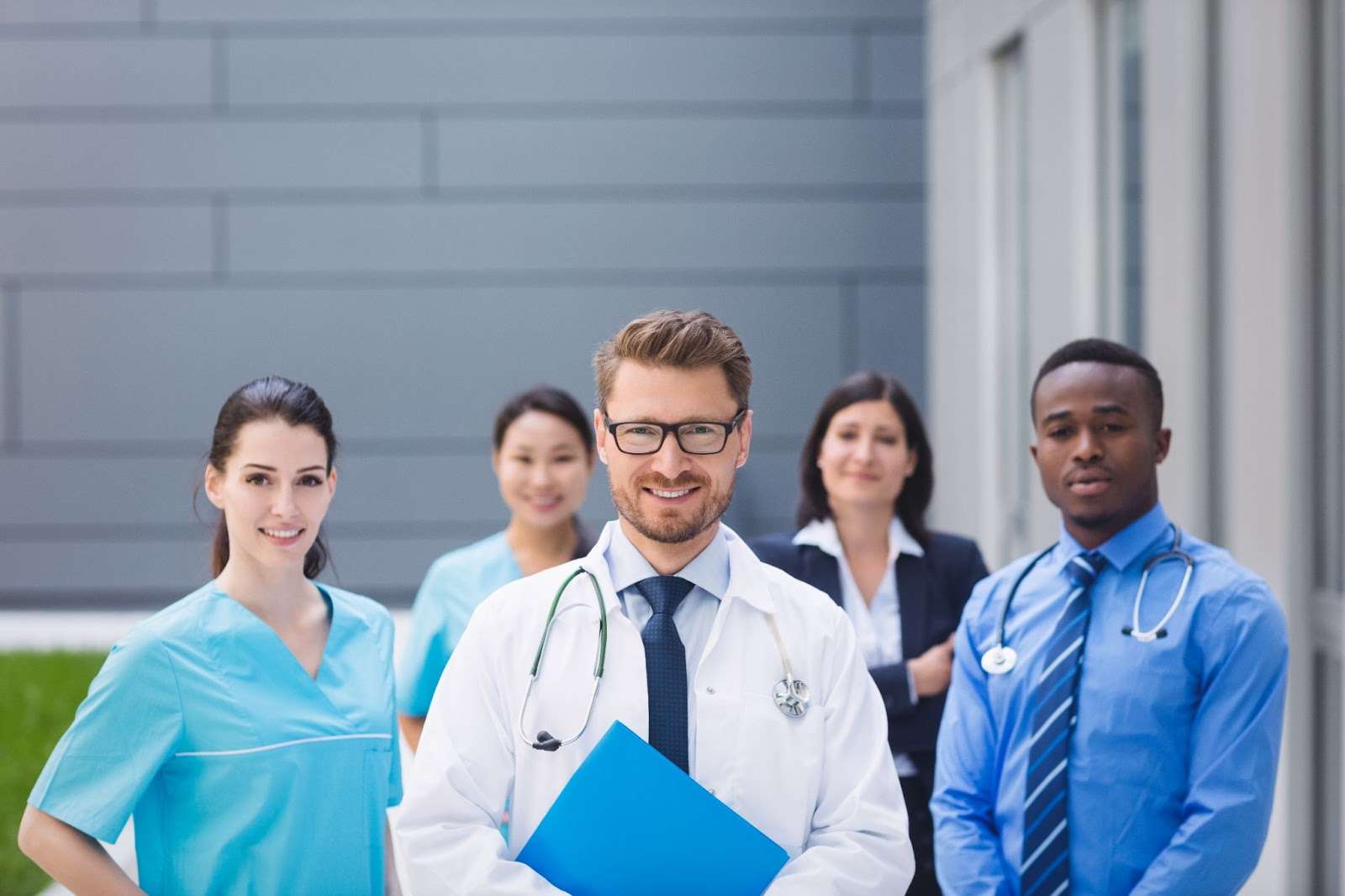 Team of healthcare practice personnel standing together - roles and responsibilities