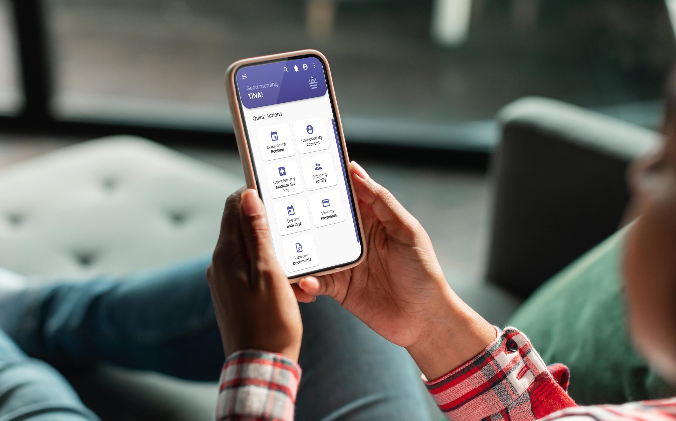 Unrecognisable person looking at their phone, which displays the MyGC app