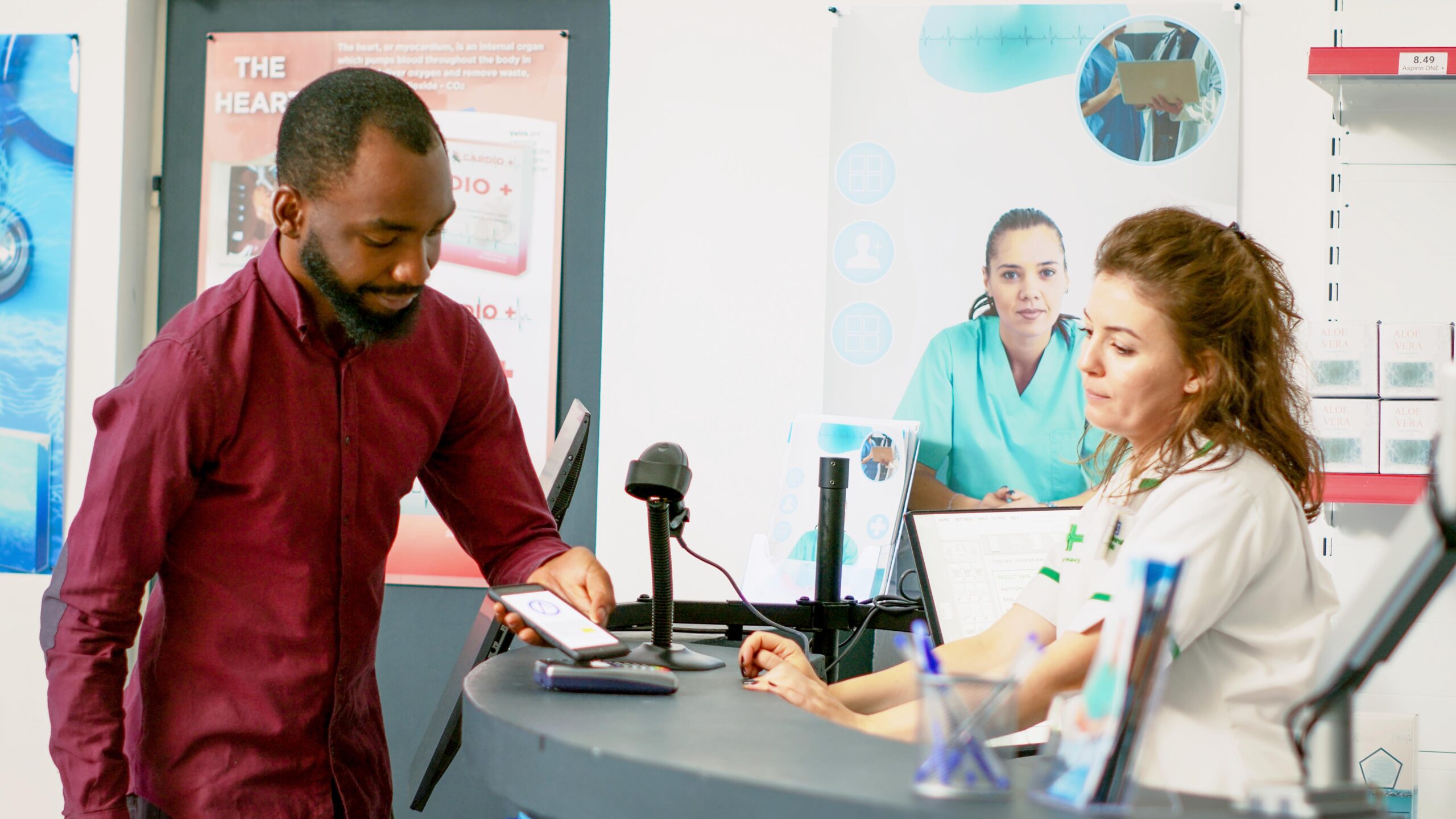 Young adult paying for treatment with mobile phone nfc on pos terminal